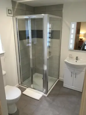 a bathroom with a shower and a toilet and a sink at The Anchor Inn in Garelochhead