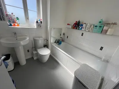 a white bathroom with a toilet and a sink at Z&Z Villa in Moffat