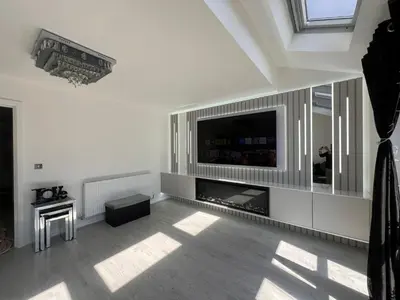 a living room with a television and a fireplace at Z&Z Villa in Moffat
