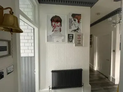 a hallway with pictures on the wall and a radiator at Rothesay, Isle of Bute in Rothesay