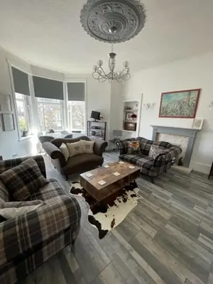 a living room with couches and a coffee table at Rothesay, Isle of Bute in Rothesay