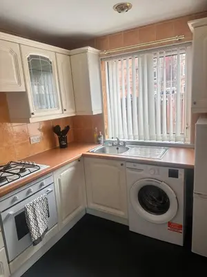 a kitchen with a washing machine and a sink at 3BR Flat Sleeps 6 West End Sights Driveway in Glasgow