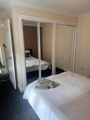 a bedroom with a bed and a mirror at 3BR Flat Sleeps 6 West End Sights Driveway in Glasgow