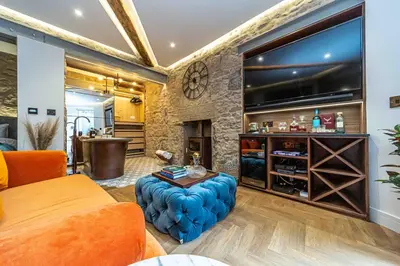 a living room with a large flat screen tv at Canon Cave in Edinburgh