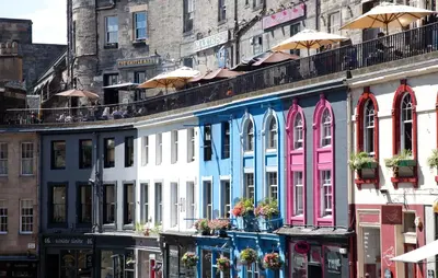 a building with colorful windows on a city street at Grassmarket Old Town Boutique Apartment in Edinburgh