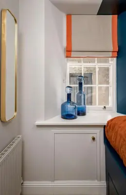a bathroom with two blue glass bottles on a shelf at Sapphire Suite, The Stirling Residence in Stirling
