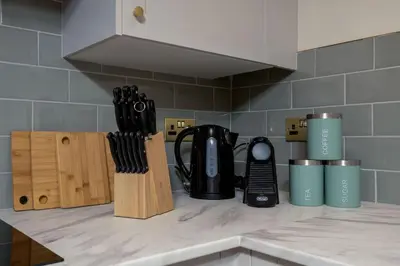 a kitchen counter with a coffee pot and knives at Bridgend Studio - Near Free Parking in Stirling