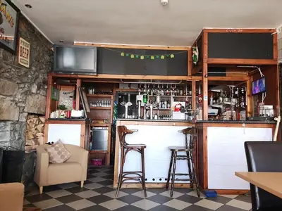 a bar in a restaurant with two stools at Summer's Bay in Rothesay