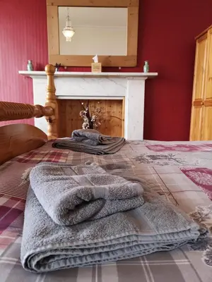 a bedroom with a bed with towels on it at Summer's Bay in Rothesay