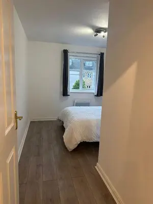 a bedroom with a bed and a window at Modern Apt commute to Edinburgh in Livingston