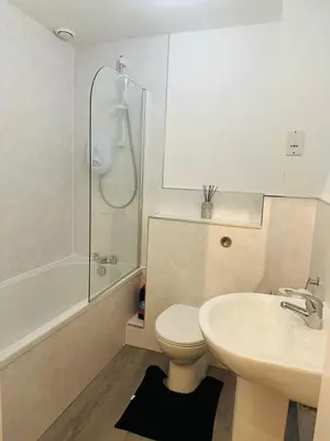 a bathroom with a toilet and a sink and a shower at Modern Apt commute to Edinburgh in Livingston