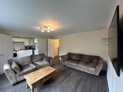 a living room with two couches and a coffee table at 2 Bed & 2 Bath-Flat-Driving Distance to Edinburgh in Uphall