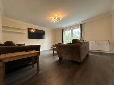 a living room with two couches and a tv at 2 Bed & 2 Bath-Flat-Driving Distance to Edinburgh in Uphall