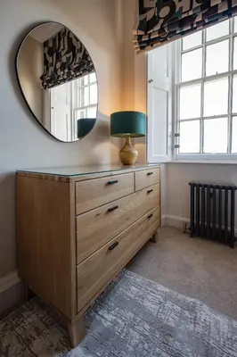 a dressing room with a mirror and a dresser at Stirling Townhouse Apartment Mid in Stirling