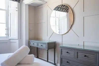 a bedroom with a mirror and a dresser at Stirling Townhouse Apartment Mid in Stirling