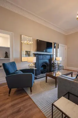 a living room with a couch and a fireplace at Stirling Townhouse Apartment Top in Stirling
