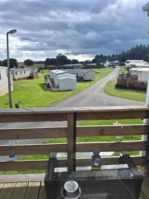 a balcony with a view of a road and buildings at The Coo Shed 94 in Newton Stewart