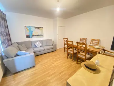 a living room with a couch and a table at Luxurious 3 rooms greater London in Moffat