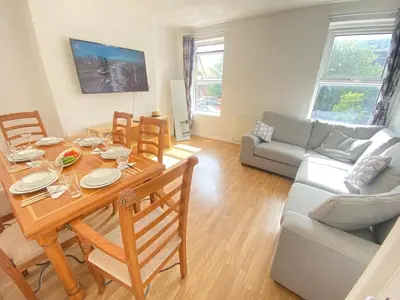 a living room with a table and a couch at Luxurious 3 rooms greater London in Moffat