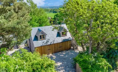 an overhead view of a blue house with a fence at Edinburgh's Springtime Chalet in Roslin