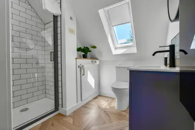 a bathroom with a shower and a toilet and a sink at Edinburgh's Springtime Chalet in Roslin