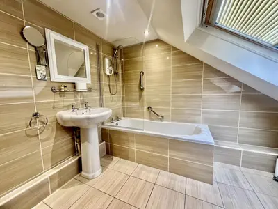 a bathroom with a sink and a bath tub at Fergus in ApartNest Auchterarder in Auchterarder
