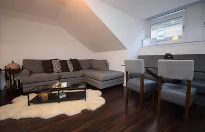 a living room with a couch and a table and chairs at Stylish Central Flat George Sq in Glasgow