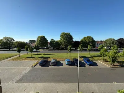 a parking lot with parked cars in a parking lot at Cosy Room with Shared Bathroom in Edinburgh