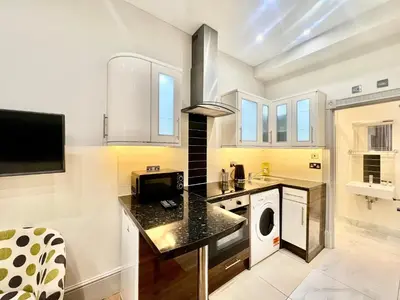 a kitchen with a washer and dryer at Collingham Road in Moffat