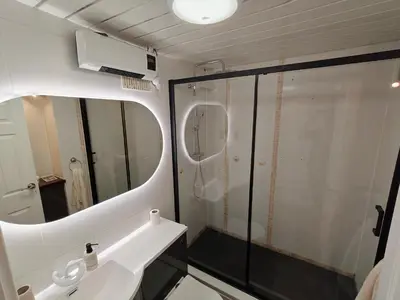 a bathroom with a shower and a sink and a mirror at Modern 2 Bed Flat in East Kilbride