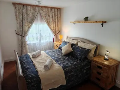 a bedroom with a bed and a window at Modern 2 Bed Flat in East Kilbride