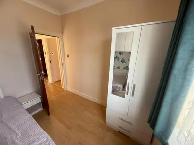 a bedroom with a bed and a closet and a door at Harrow Inn Rooms in Yarrow