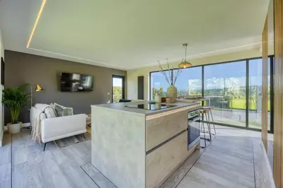 a kitchen with a large island in a living room at Retreat to the Campsies in Lennoxtown