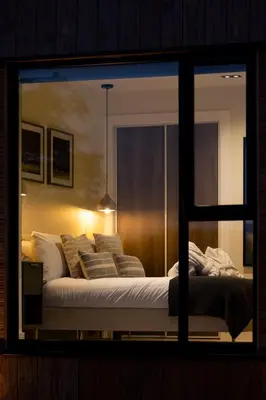 a bedroom with a large bed with pillows at Retreat to the Campsies in Lennoxtown