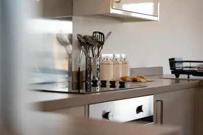 a kitchen with a counter top with utensils at Macallan Apartment in Oban