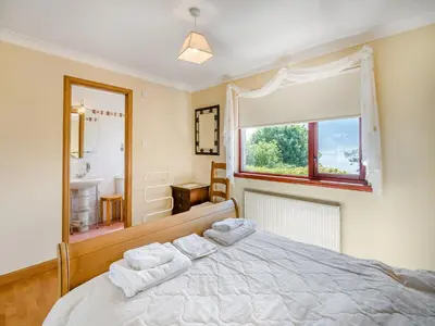 a bedroom with a bed with two towels on it at Kilbride in Lamlash