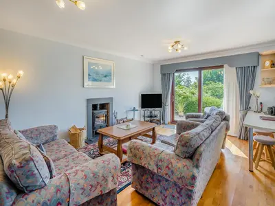 a living room with two couches and a television at Kilbride in Lamlash