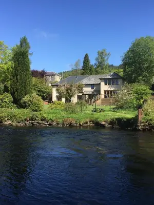 a house on the banks of a river at Riverside House in Callander