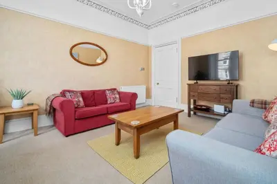 a living room with two couches and a tv at Stunning 2BR Apt - Central, Argyll Square Views in Oban