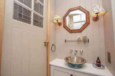a bathroom with a sink and a mirror at Luxury Wood panelled West End GF Flat in Edinburgh