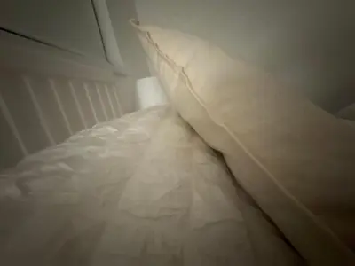 a white pillow sitting on top of a bed at Home stay in Moffat