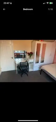 a room with a desk and a bed and white cabinets at Coven in Moffat