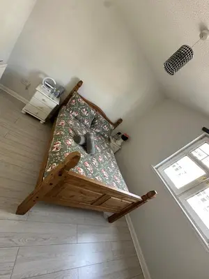 a bed in the corner of a room at Old Town Place in Edinburgh