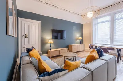 a living room with a couch and a table at 3BR Gem West End Walk to Glasgow Uni Parking in Glasgow