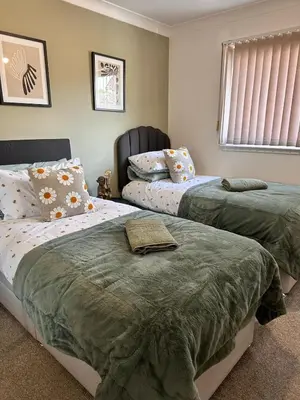 a bedroom with two beds with pillows and a window at 2BR Flat Free Parking Near Hampden and O2 Academy in Glasgow