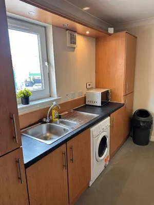 a kitchen with a sink and a microwave at 2BR Flat Free Parking Near Hampden and O2 Academy in Glasgow