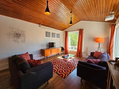 a living room with two couches and a tv at The Robin House in Ravelston in Edinburgh
