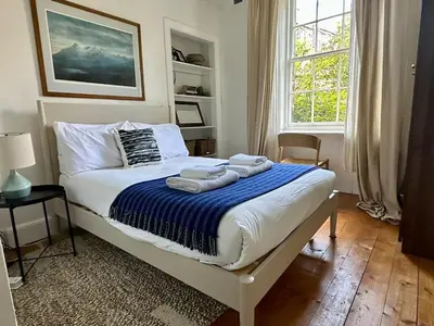 a bedroom with a bed with towels on it at Grindlay St - Fantastic 2BR in Theatre District in Edinburgh