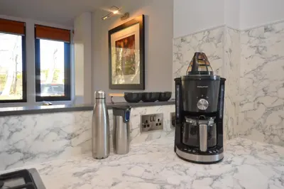 a blender sitting on top of a counter in a bathroom at Cliff Top - Bubbling Springs in Wemyss Bay