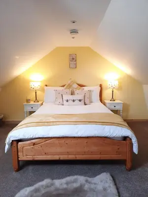 a bedroom with a large bed with two lamps at A Stylish Country Retreat! in Keilour